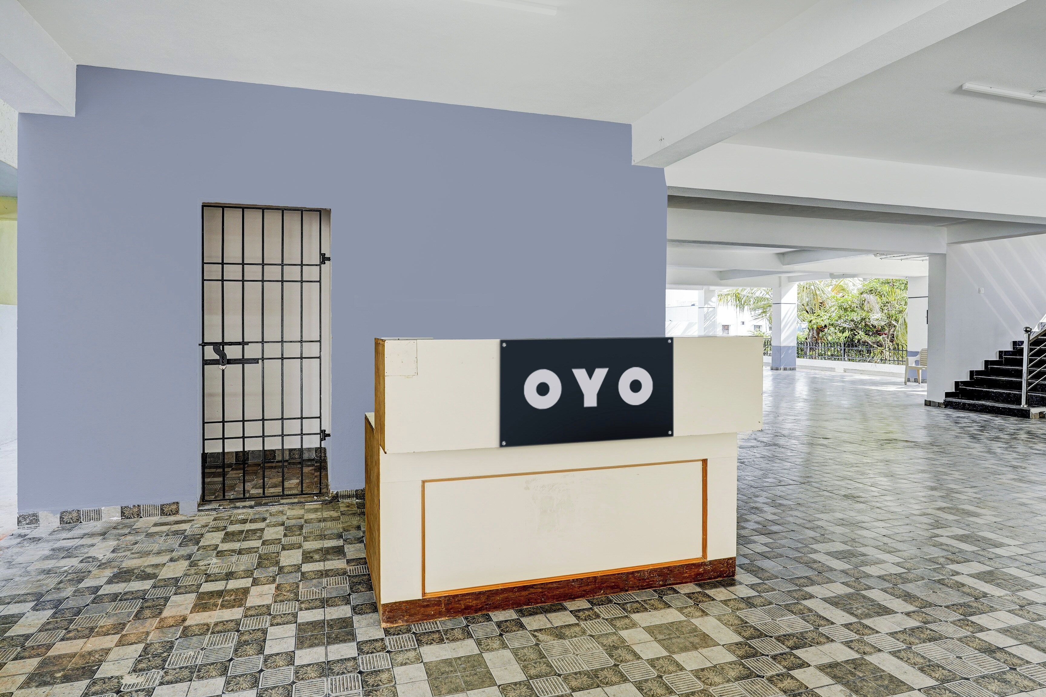 A modern interior with a tiled floor, a blue wall, and a sign that reads 'OYO'.