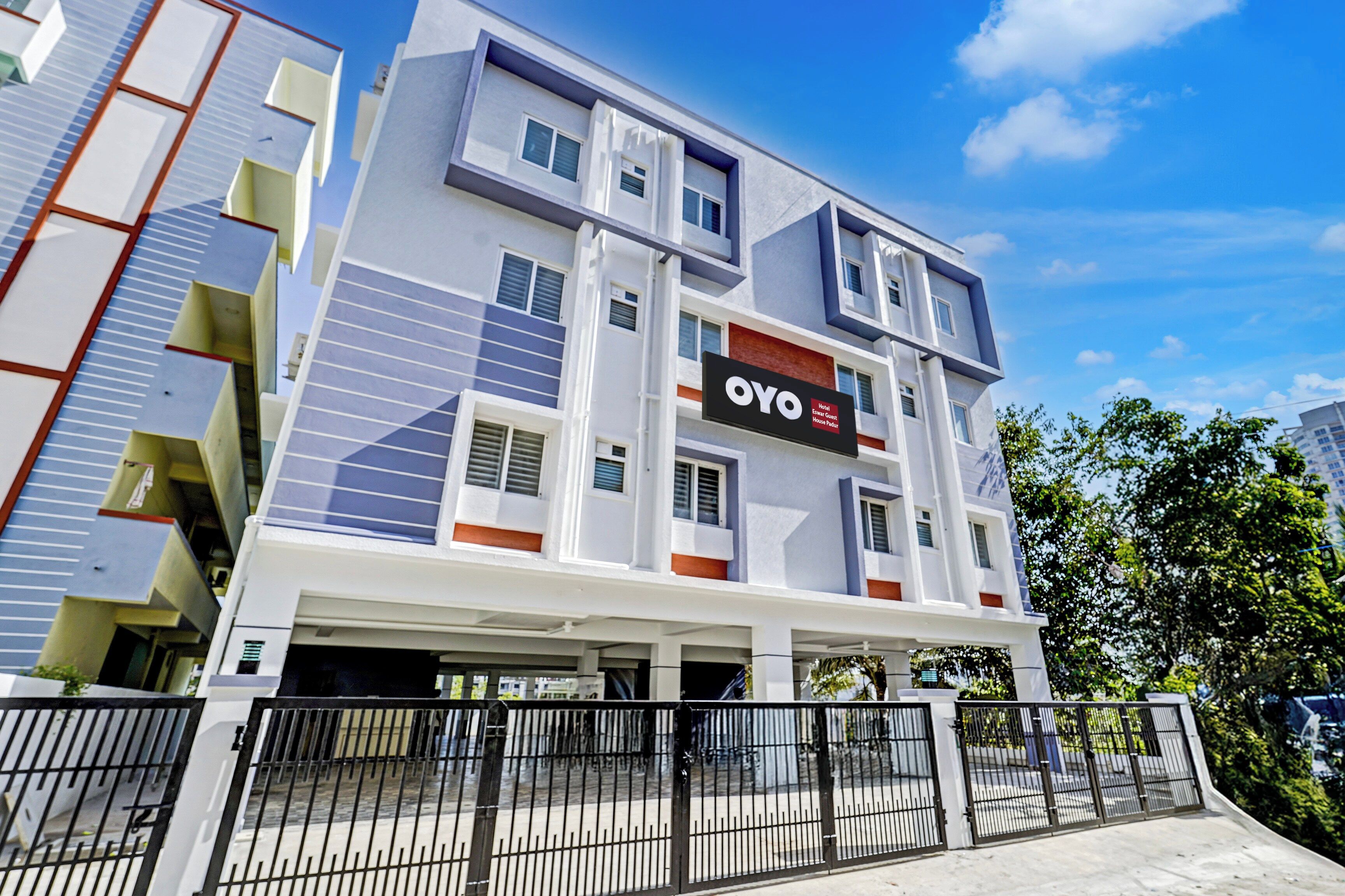 A multi-story hotel building with a modern architectural design, featuring a prominent sign for the hotel named 'OYO'.