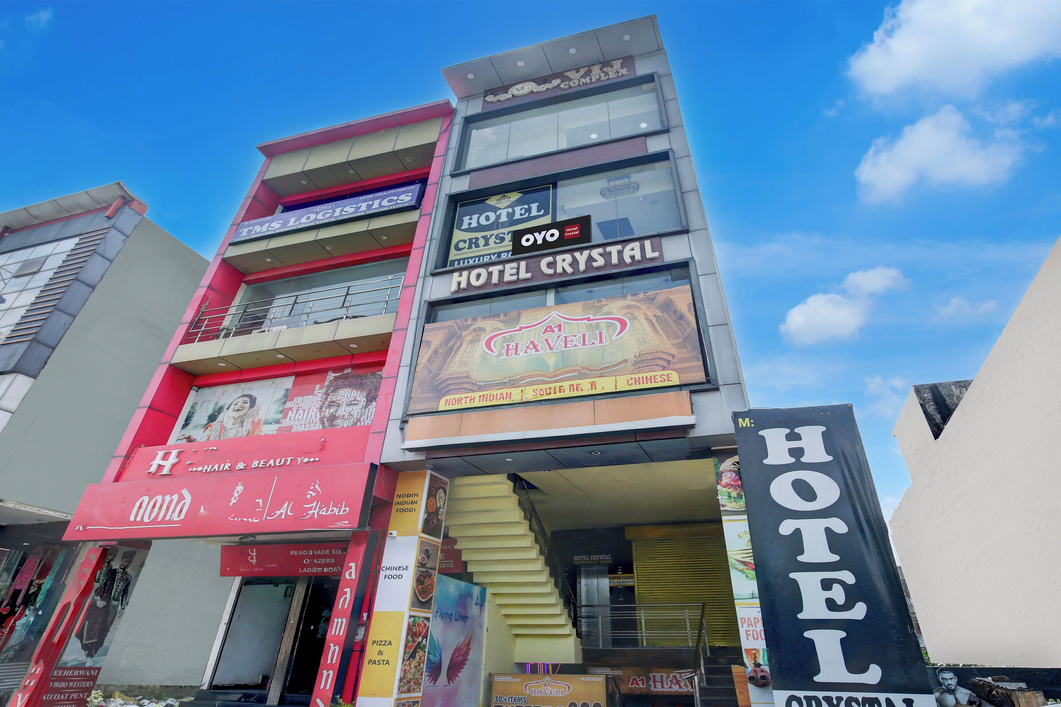 A multi-story building with various commercial establishments including a hotel, a hair salon, and a restaurant.