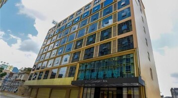 A multi-story hotel with a modern facade, large windows, and a sign indicating it is a Comfort Inn.