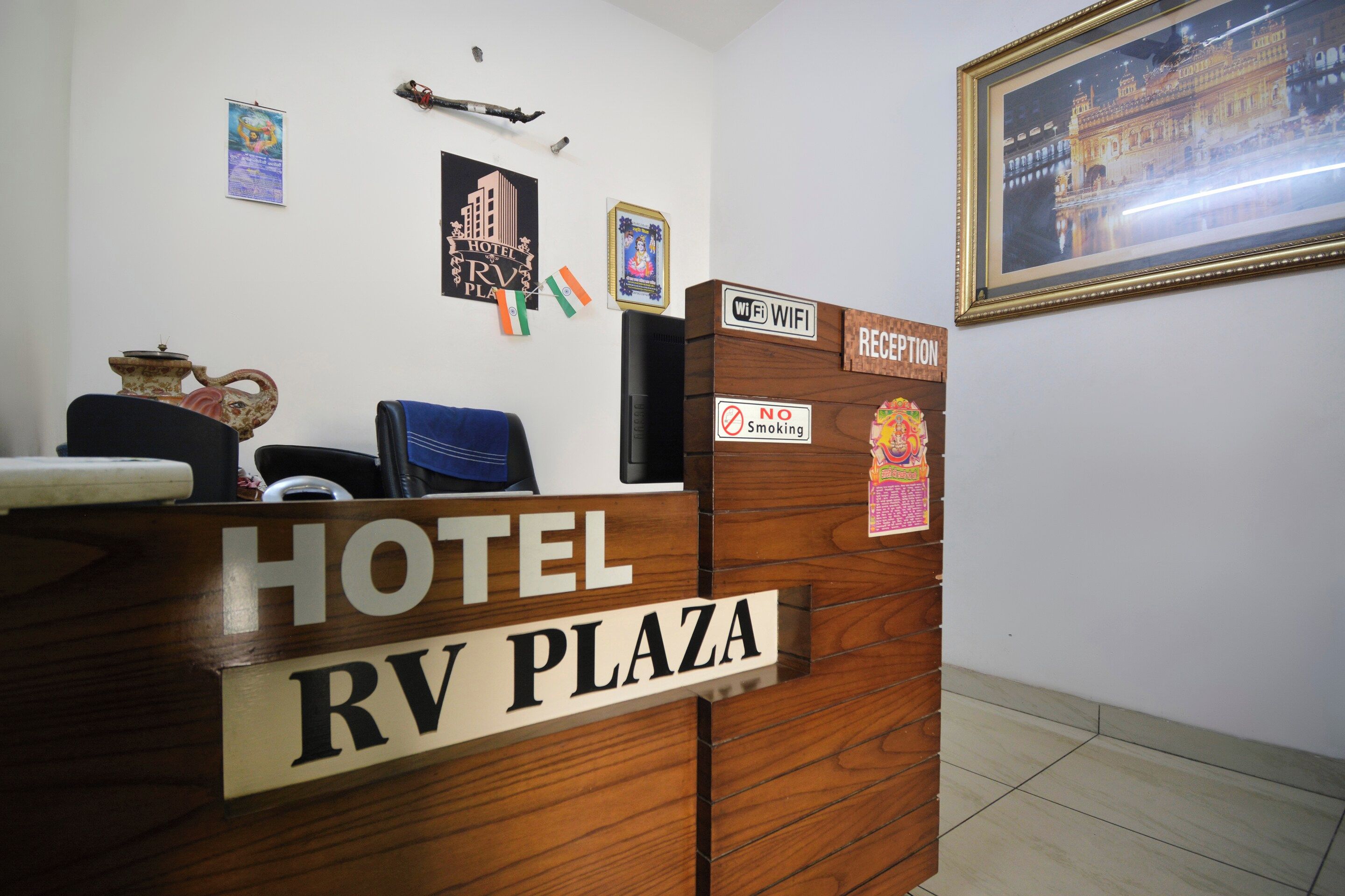 A hotel reception desk with a sign reading 'HOTEL RV PLAZA'.