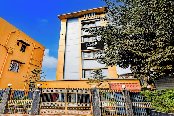 A multi-story building with a prominent 'Collection' sign, a gated entrance, and a clear blue sky. - Super Collection O SF Road Siliguri (Siliguri)