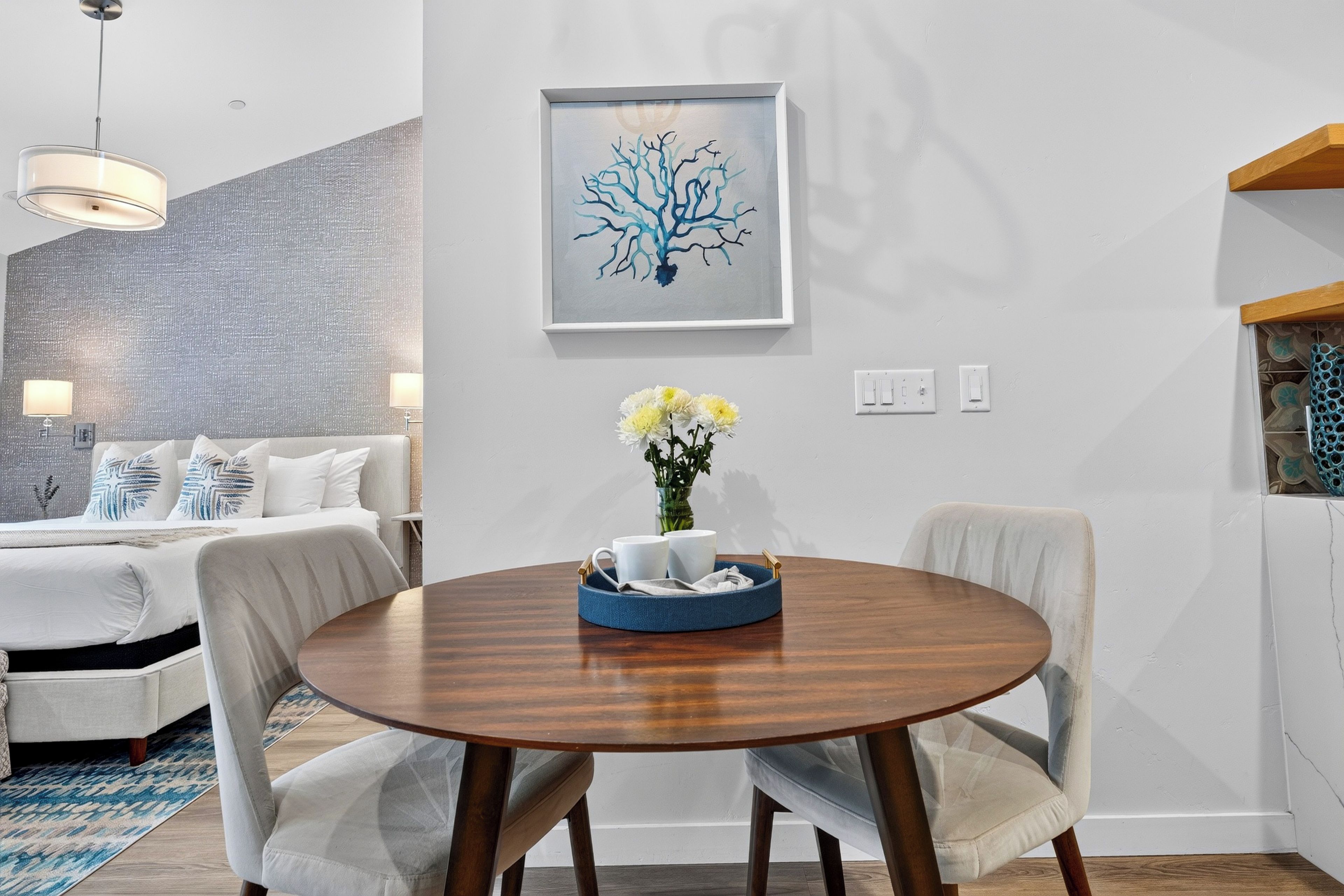 Enjoy a quiet coffee or takeout for two at the bistro table, with the studio's inviting sleeping area just beyond.