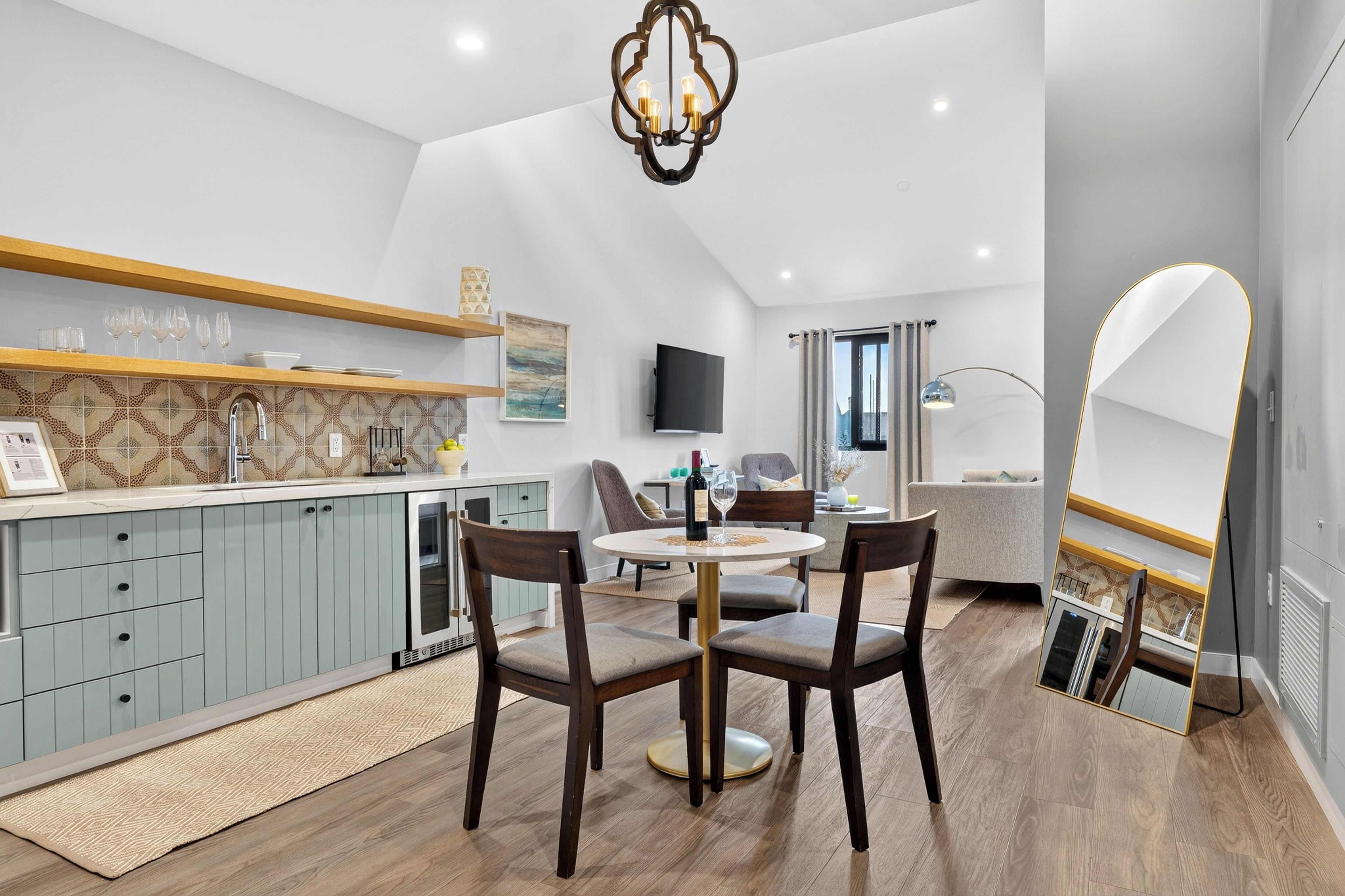 A welcoming open-plan view brings together the kitchenette, dining nook, and comfortable lounge beneath high ceilings.