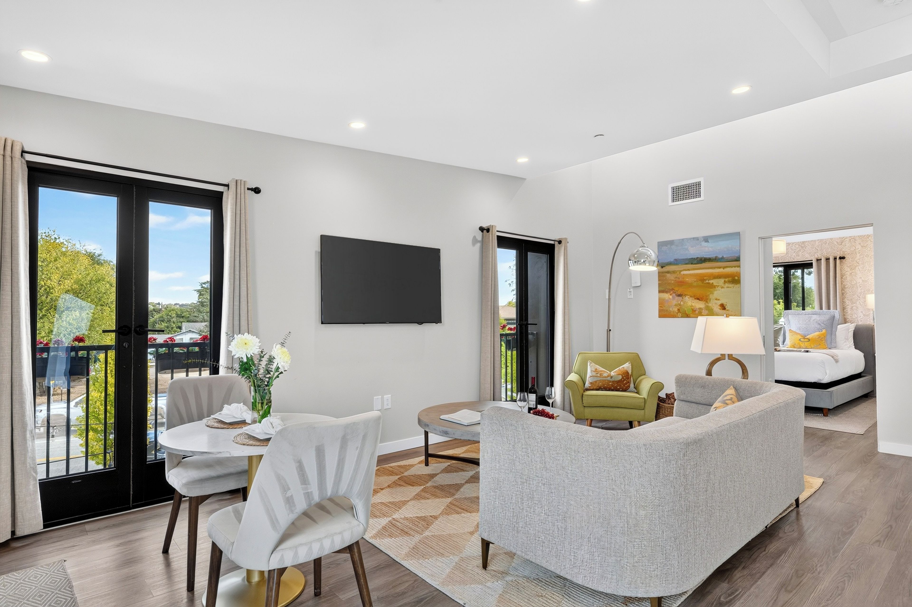 Unwind in the open living area, with comfortable seating, natural light, and direct access to a private balcony.