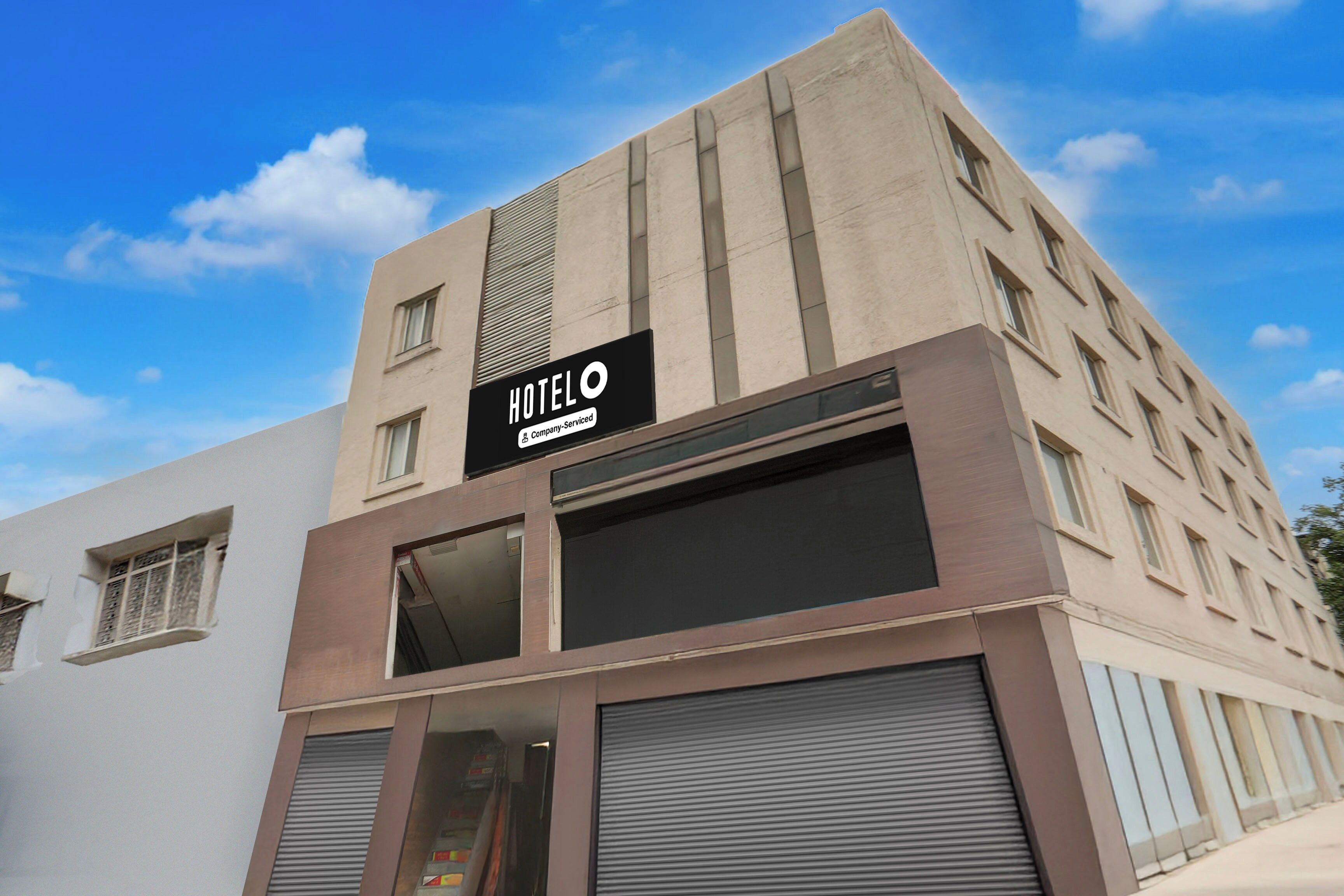 A hotel building with a sign indicating it is company-serviced.