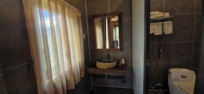 A bathroom with a stone sink, a mirror, a towel rack, and a shower area. - Osima Villas Mu Cang Chai (Pung Luong)
