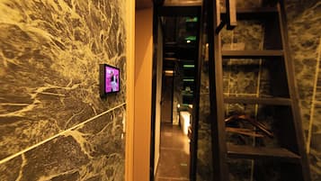 A marble wall with a digital screen displaying a cat image.