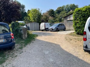 A gravel driveway leading to a building with parked cars and a shed. - New Listing (Les Avenières Veyrins-Thuellin)
