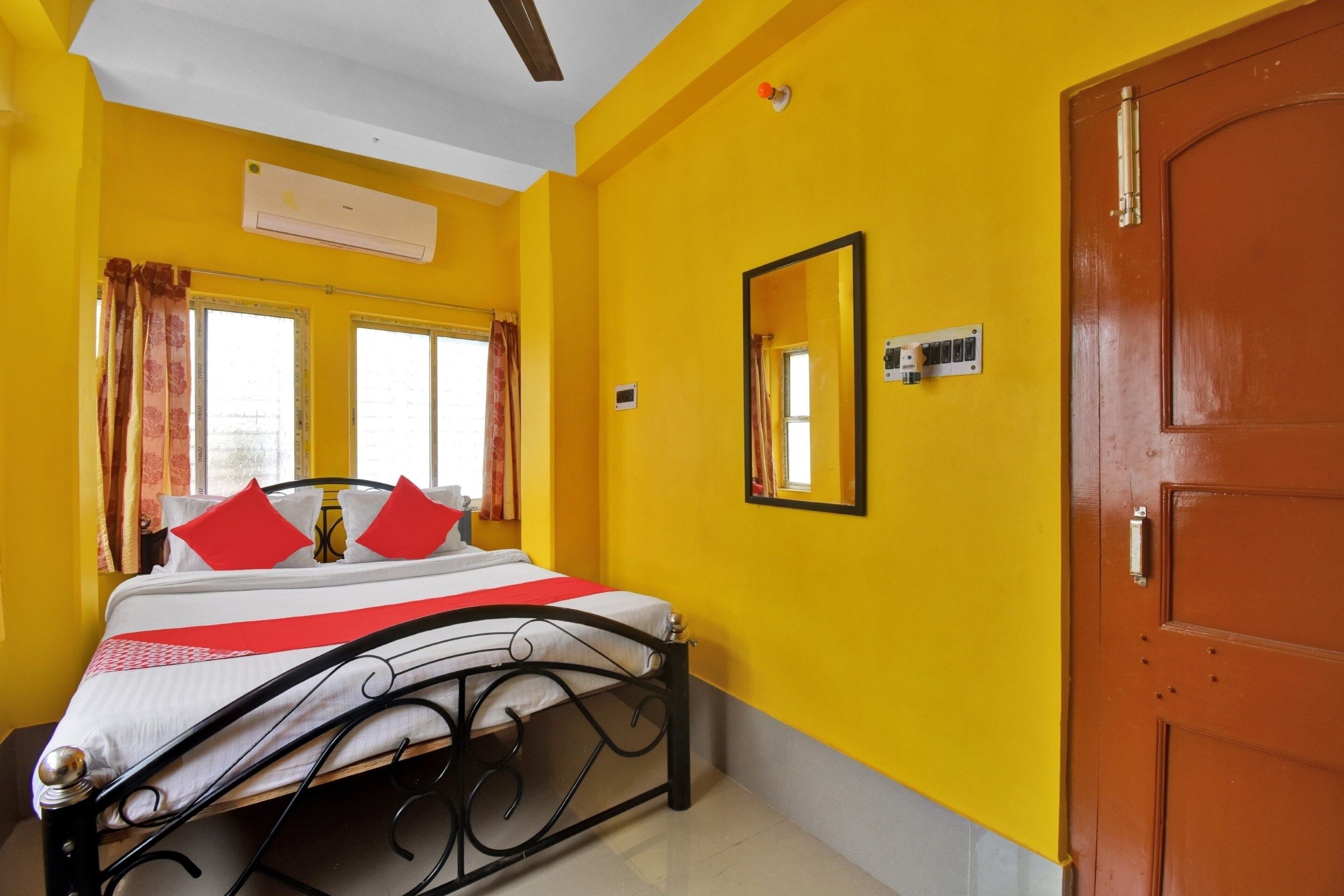 A room with a bed, a door, and a window.