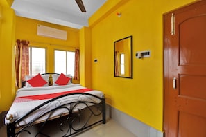A room with a bed, a door, and a window. - Hotel O Palace (Kolkata)