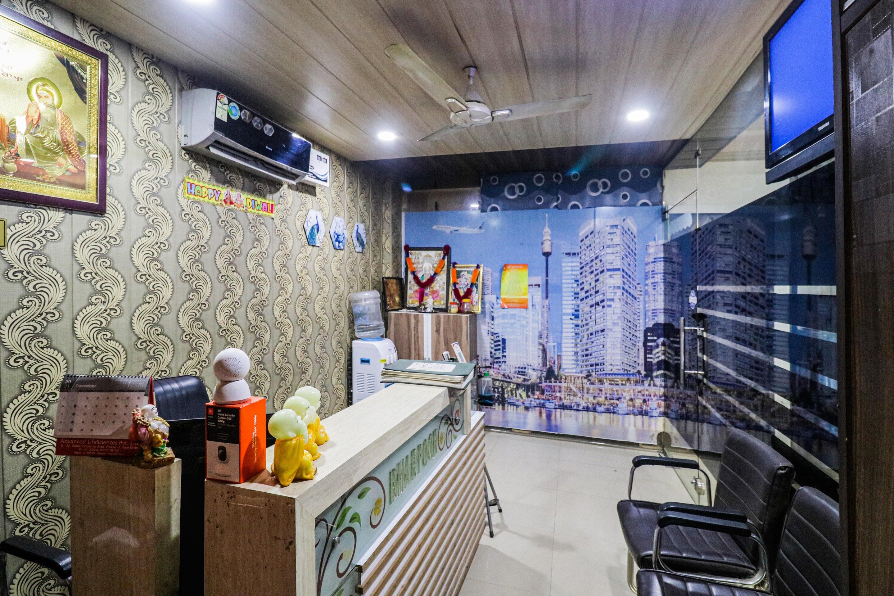 A reception area with patterned wallpaper, a reception desk, a water dispenser, and a cityscape mural on the wall.