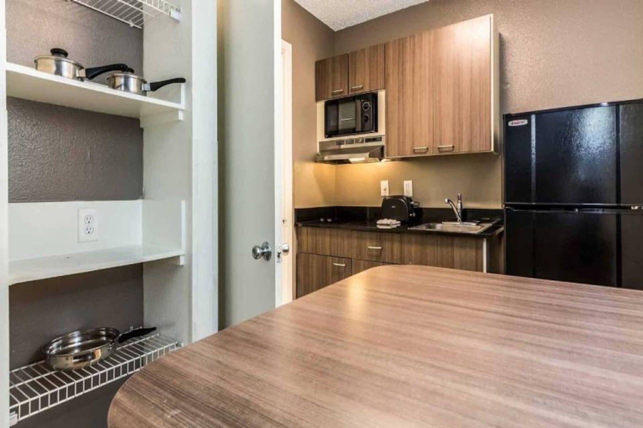 A compact kitchen with a microwave, stove, and refrigerator.