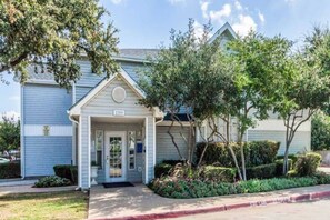 A residential building with a front entrance, a mailbox, and a number sign. - 1 Queen Bed | ADA/RI Shower| NS (Dallas)