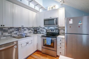 A modern kitchen with white cabinetry, a stainless steel refrigerator, a microwave, and a stove. - 2 Mi to Bryce Resort! All-Season Condo w/ Views (Basye)
