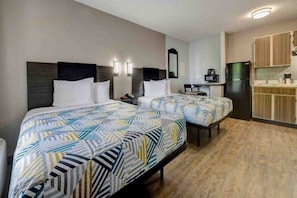 A hotel room with two beds, a kitchenette, and a small desk. - 2 Full Beds | ADA/Roll-In Shower, Smoking (Arlington)