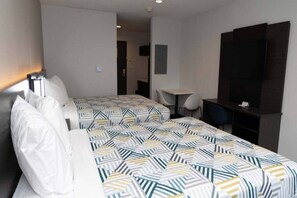 A hotel room with two beds, a desk, a chair, a TV, and a wardrobe. - 2 Queen Beds | Mobil Access Tub Nsmk Kitchen (FORT WORTH)