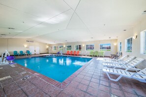 An indoor swimming pool with clear water, surrounded by lounge chairs and a tiled floor. - 2 King Beds | Suite, Non-Smoking (Decatur TX)