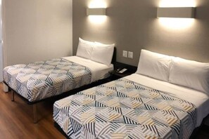 Two twin beds with patterned bedding, a bedside table with a phone, and wall-mounted lighting. - M6 Paris, Tx_2 Full Beds | Smk, Micfridge (Paris)