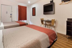 A hotel room with two beds, a desk with chairs, a TV, and a wardrobe. - 2 full beds | smoking, micfridge (Fort Worth)