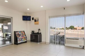 A reception area with a coffee station, a magazine rack, and a television on the wall. - 2 full beds | smoking, micfridge (Fort Worth)