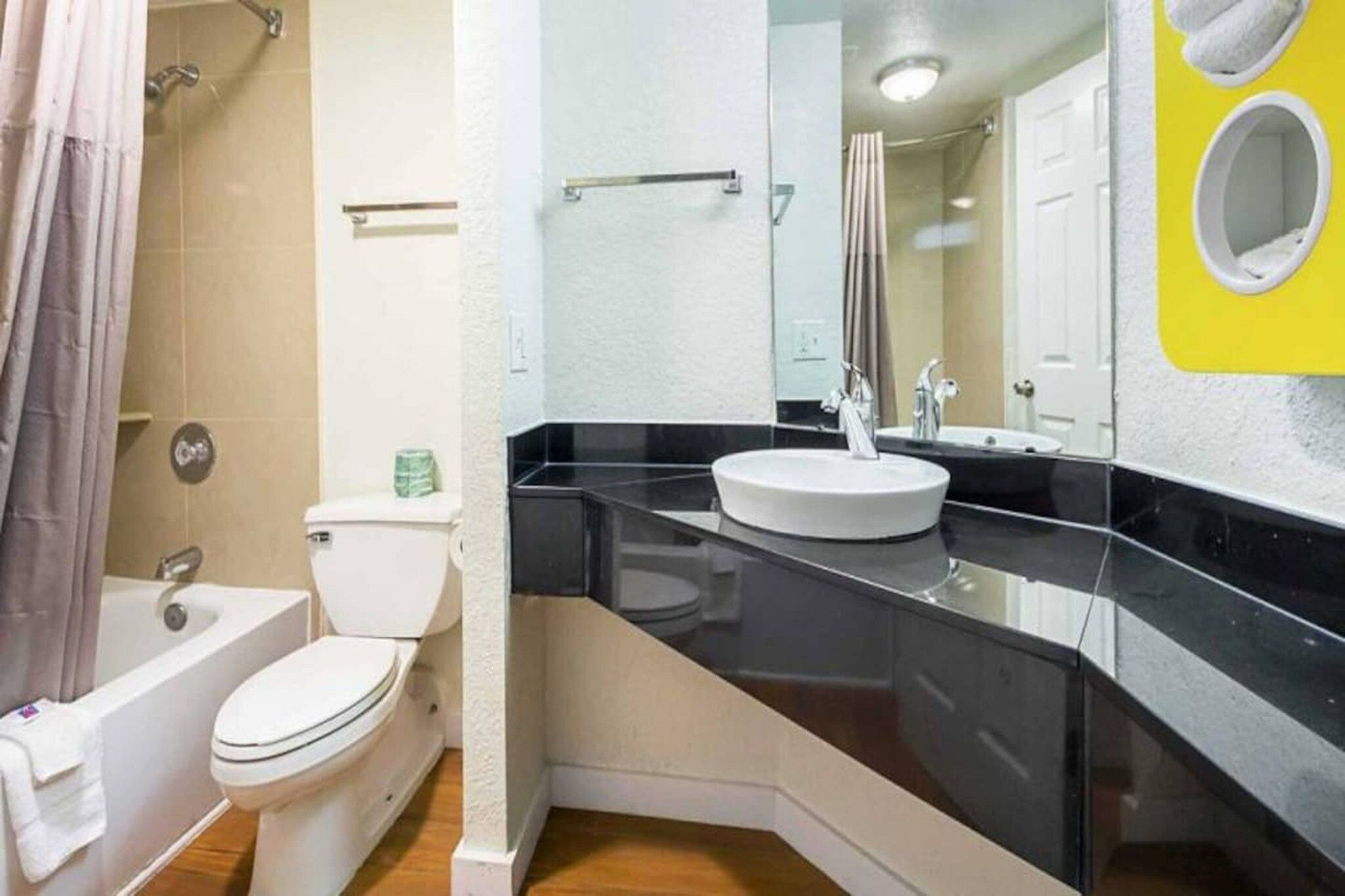 A bathroom with a toilet, a bathtub, a sink, and a shower.