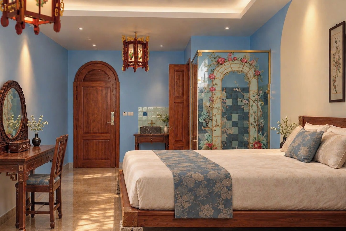 A bedroom with a bed, a dresser, a mirror, and a decorative wall.