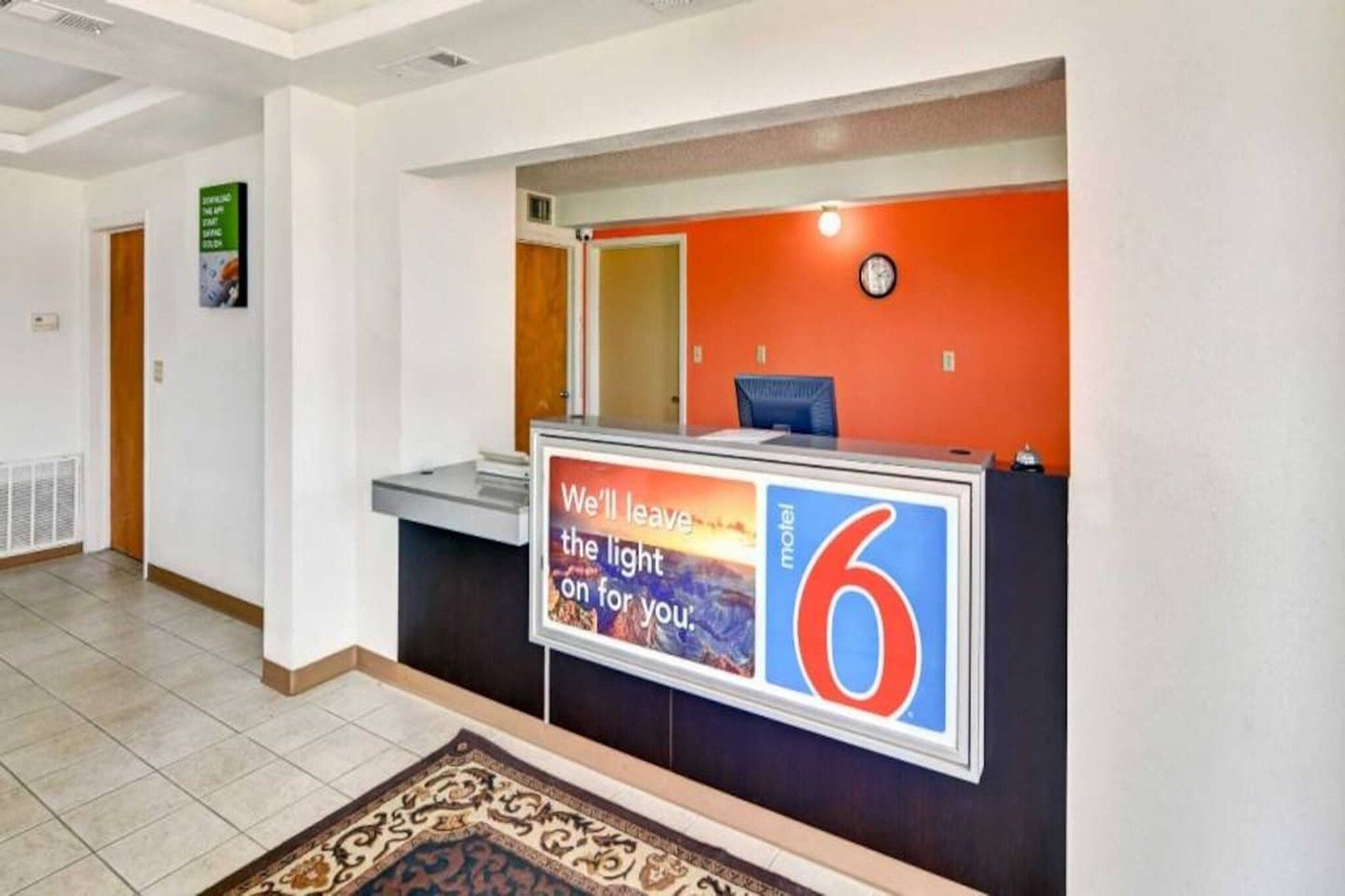 A hotel reception desk with a sign indicating the number 6.