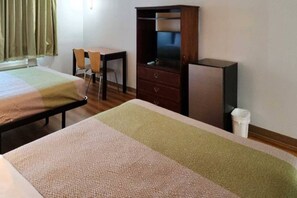 A hotel room with two beds, a desk, a television, and a wardrobe. - 2 Queen Beds | Non-Smoking (Ennis)