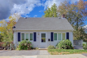 A single-story house with a gabled roof, a front door, and a small porch. - Lakefront Unit w/ Views, Near Colleges & Hospitals (Worcester)