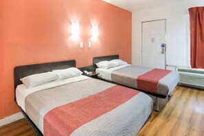 A hotel room with two beds, a door, and a window with curtains. - 2 full beds | non-smoking, micfridge (Fort Worth)