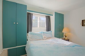 A bedroom with a bed, a window with curtains, a nightstand with a lamp, and teal-colored wardrobes. - Private Hot Tub & Mtn Views! Salem Escape (Salem)