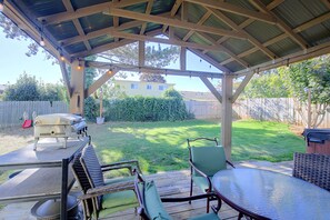 A covered outdoor patio with a grill, seating area, and a view of the backyard. - Private Hot Tub & Mtn Views! Salem Escape (Salem)