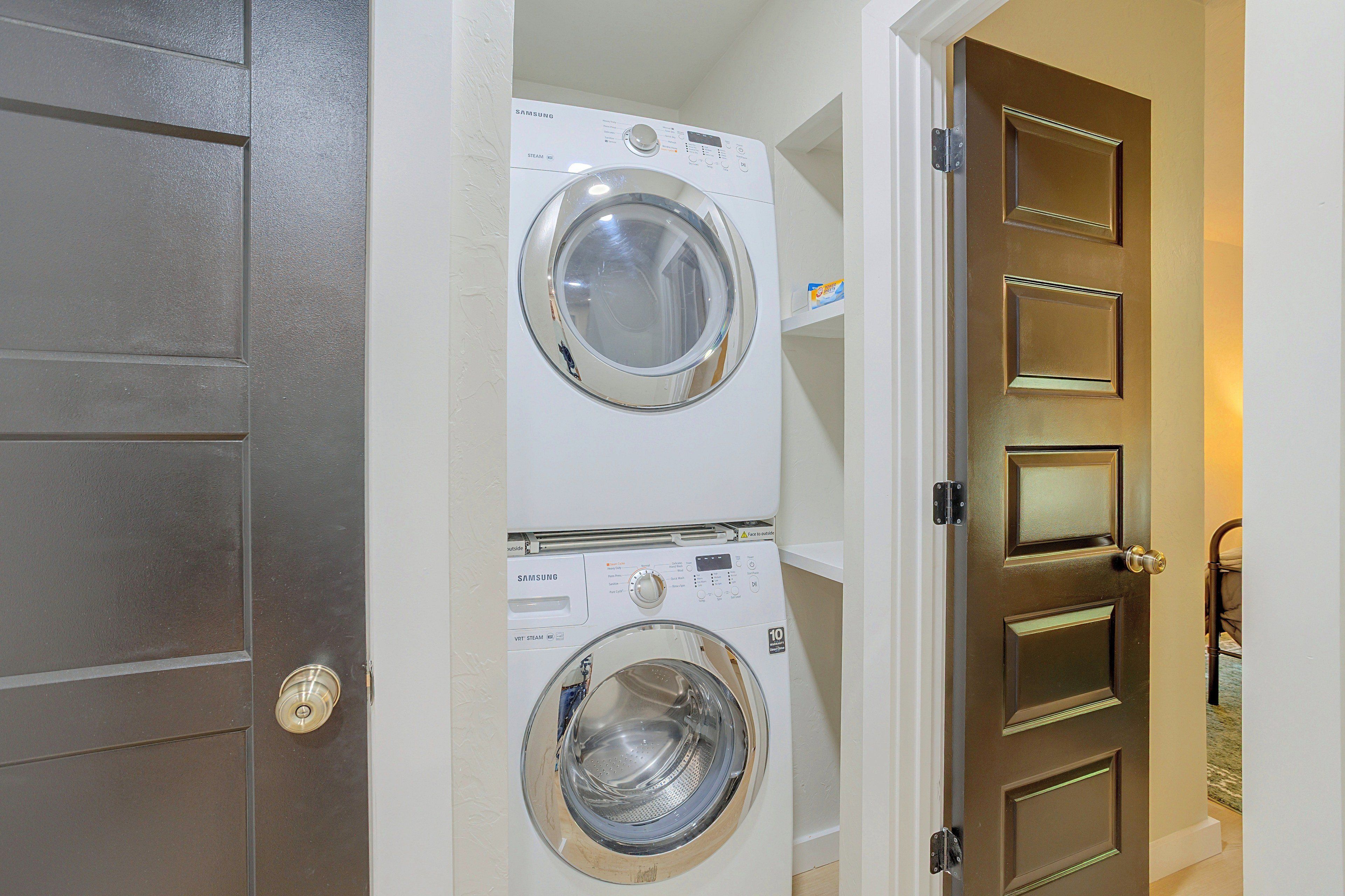 A laundry room with two stacked front-loading washing machines.