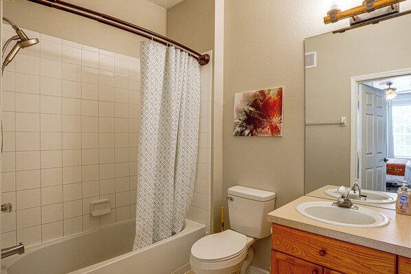 A bathroom with a shower, toilet, sink, and a mirror. - Resort Perks! Family Condo 4 Mi to Disney World! (Kissimmee)