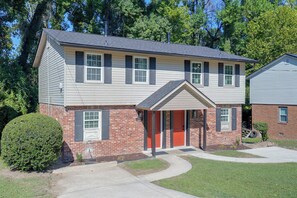 A two-story house with a front porch, a brick foundation, and a well-maintained lawn. - 6 Mi to the Masters: North Augusta Condo (North Augusta)