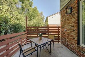 A patio with a table and chairs, a brick wall, and a wooden fence. - Duplex 6 Miles to downtown Augusta (North Augusta)