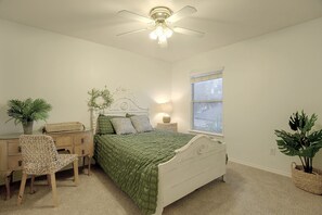 A bedroom with a bed, a chair, a dresser, a window, and a ceiling fan. - Private Pool! Home 4 Mi to Old Town Spring (Spring)