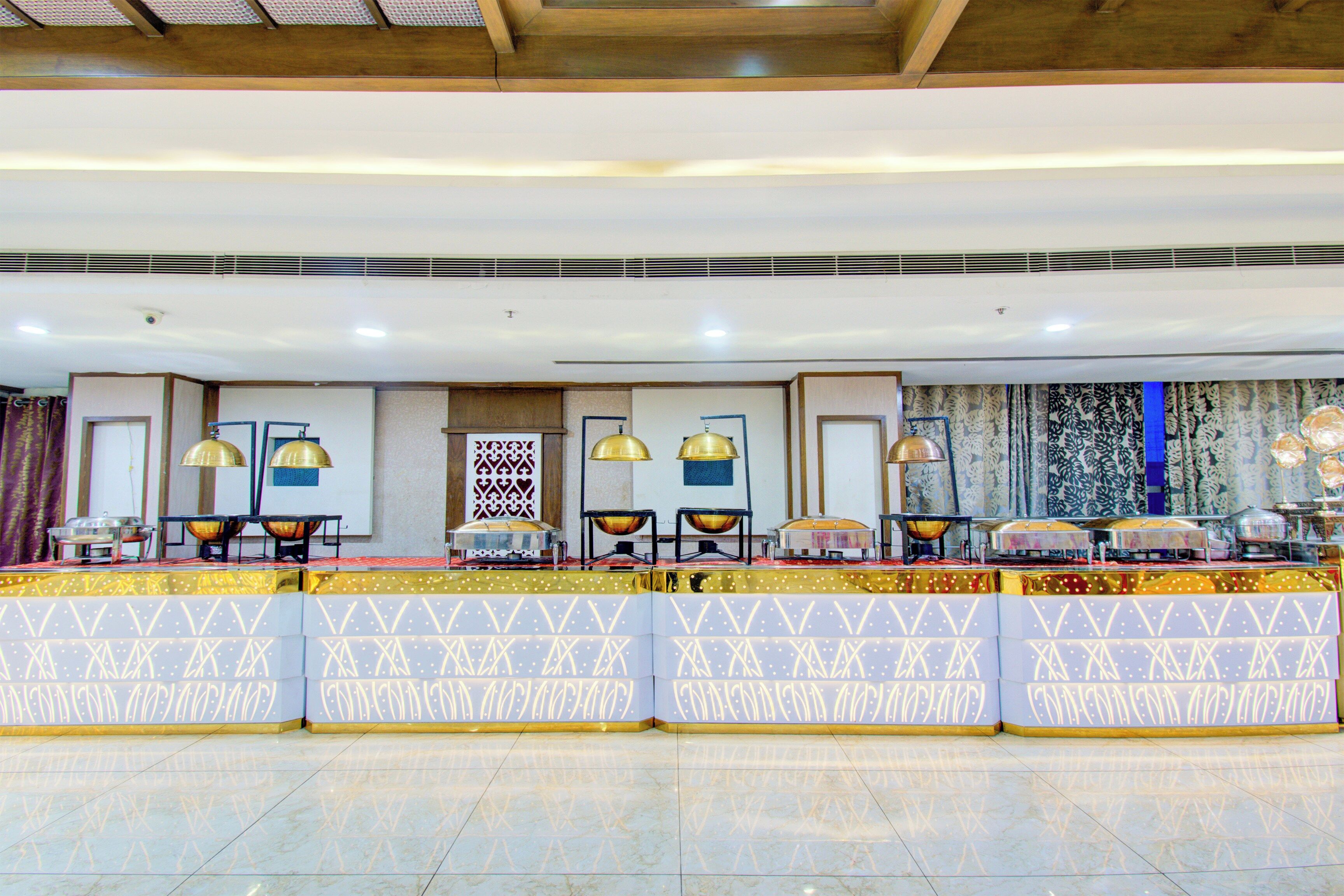 A reception area with a counter, multiple lamps, and a patterned wall.