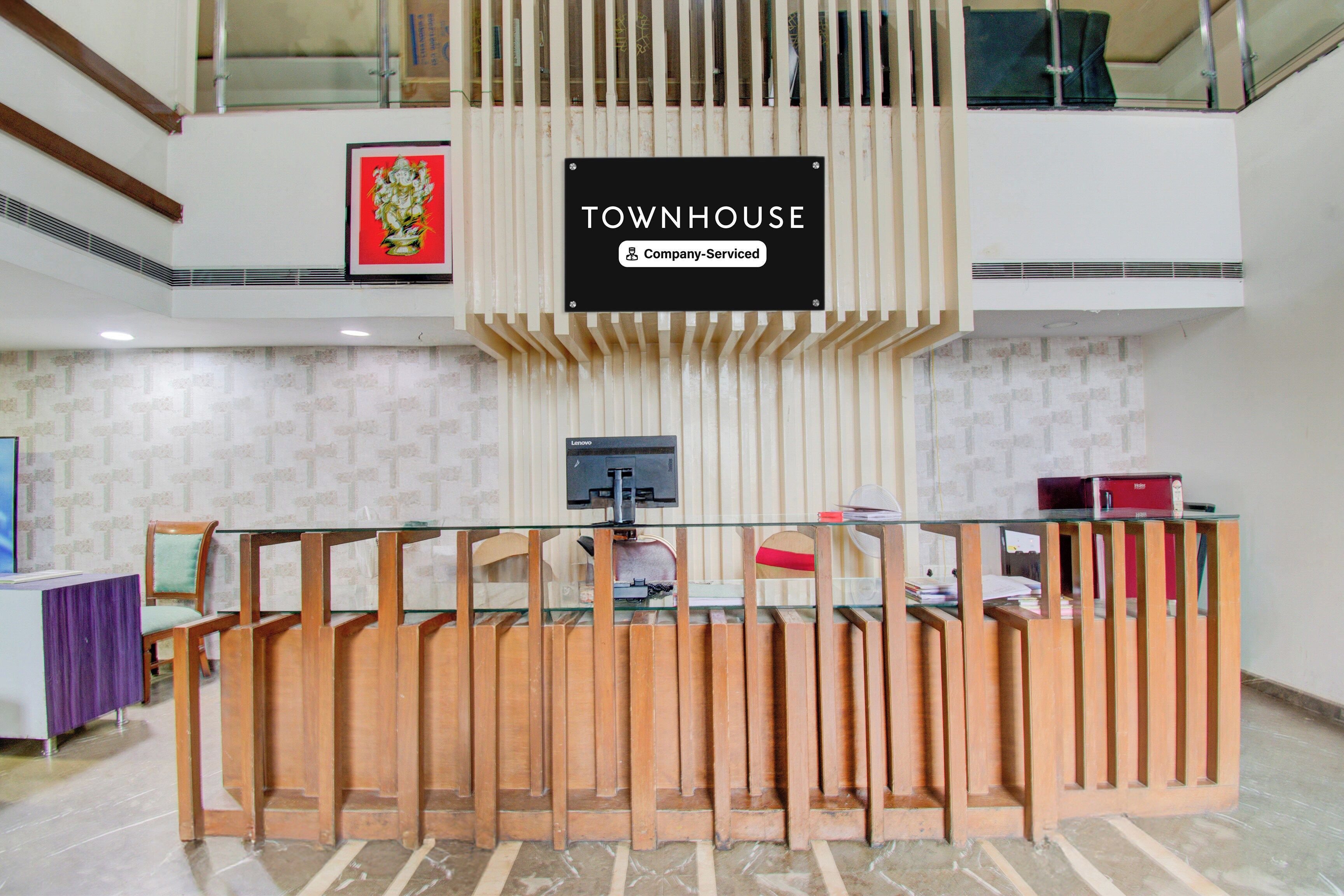 A reception desk with a sign indicating it is a company-serviced townhouse.