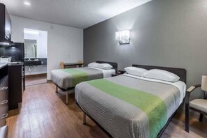 A hotel room with two beds, a desk, a chair, and a television. - 2 Full Beds | Non-Smoking, Kitchen (BRYAN)