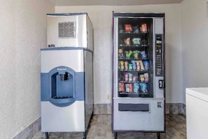 A water dispenser and a vending machine in a room.