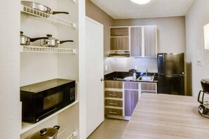 A compact kitchen with a microwave, stove, and refrigerator. - 2 Full Beds | ADA/Tub, Nsmk (Houston)