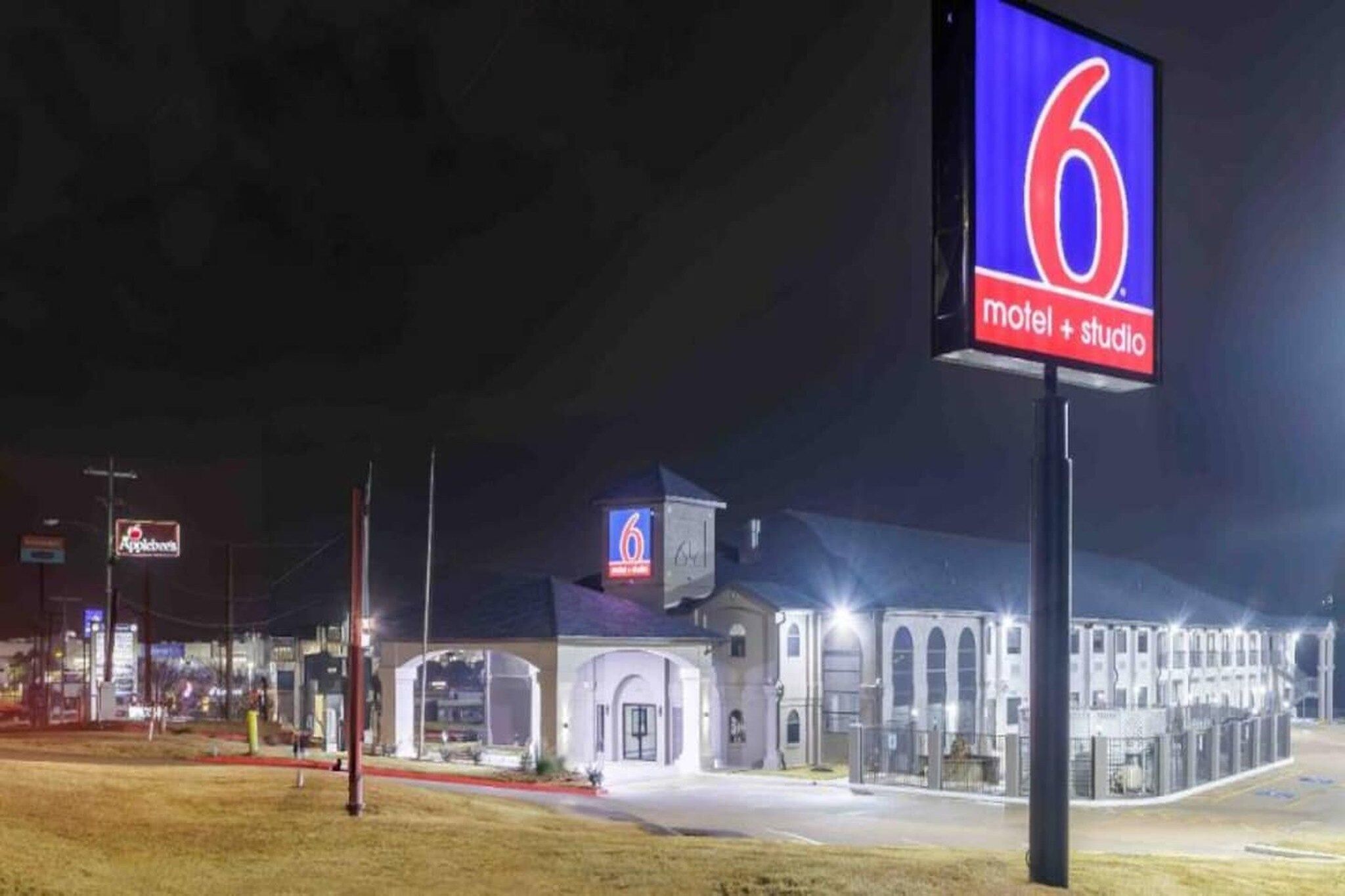 A motel with a prominent '6' sign, a large building with arched windows, and a 'motel + studio' label.