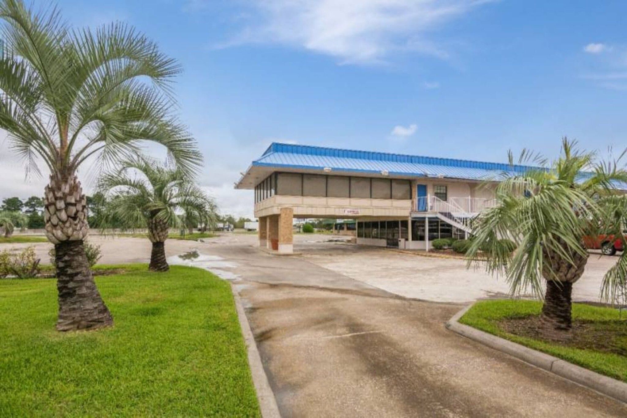 A building with a blue roof and a covered entrance area.