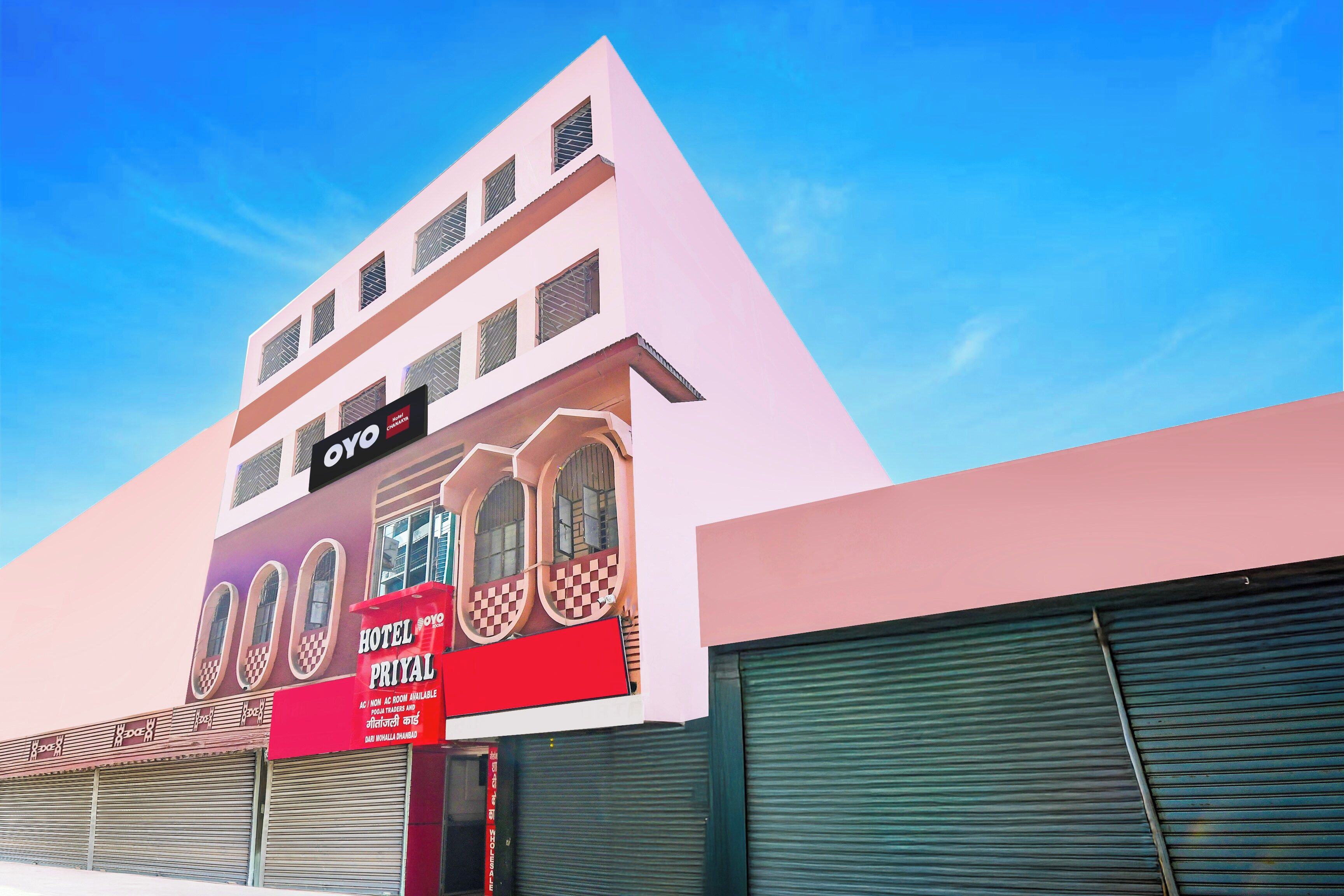 A hotel with a modern facade, a prominent signboard, and a large window display.