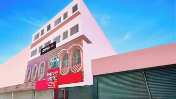 A hotel with a modern facade, a prominent signboard, and a large window display.