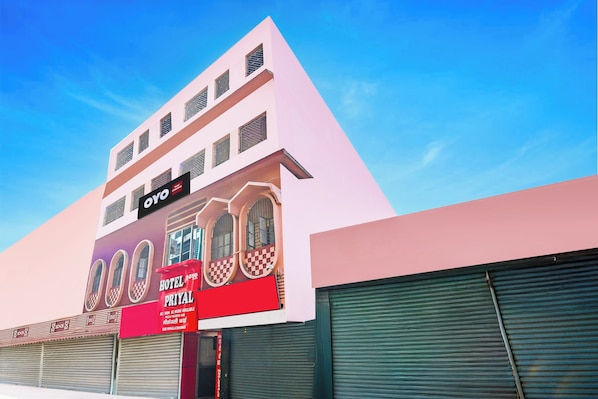 Un hotel con fachada moderna, un cartel llamativo y un amplio escaparate.