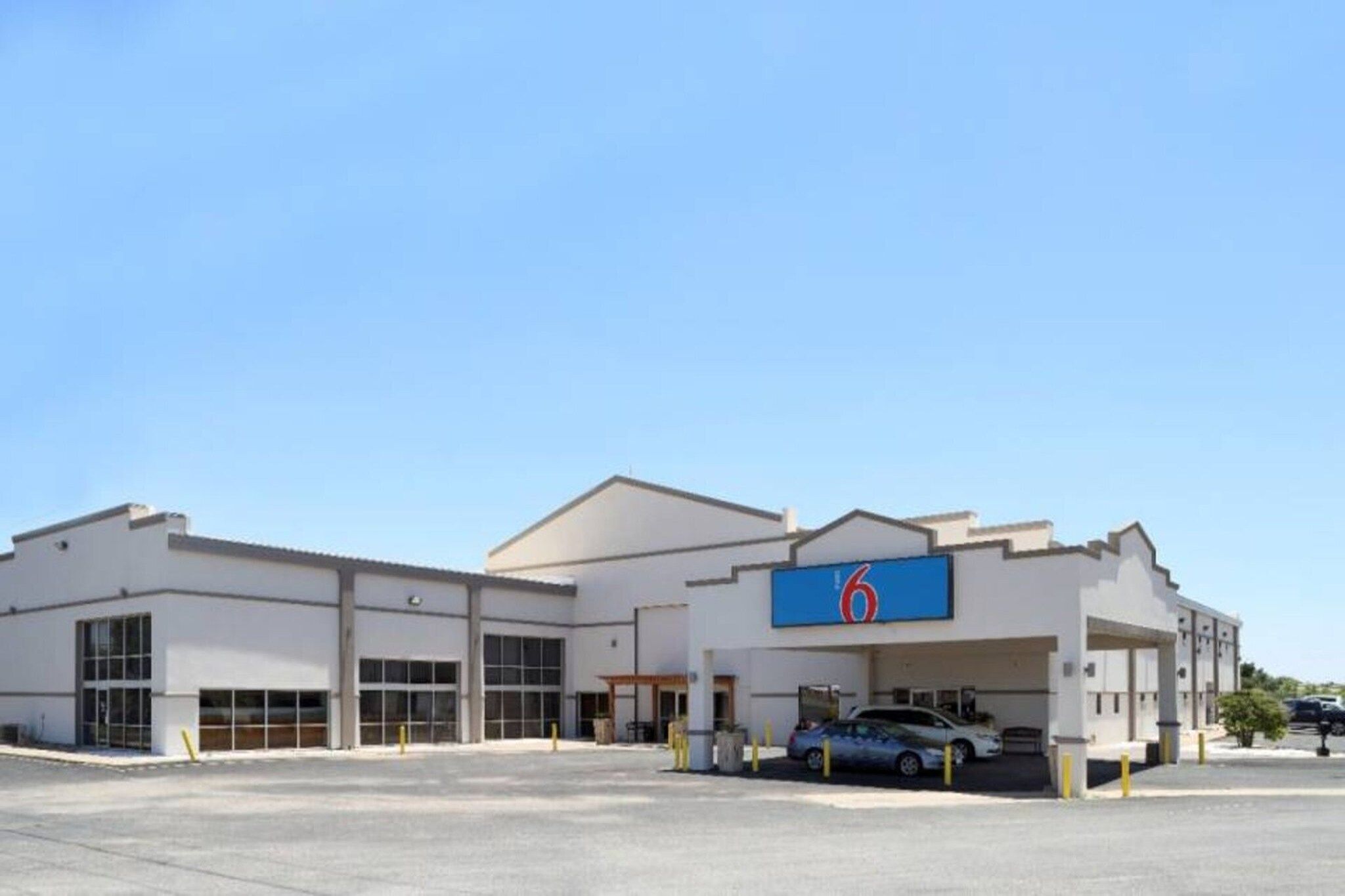 A 6-story building with a parking garage and a large sign.