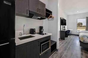 A compact kitchenette with a refrigerator, sink, and oven. - 2 Queen Beds | Non-Smoking, Kitchen (Katy)